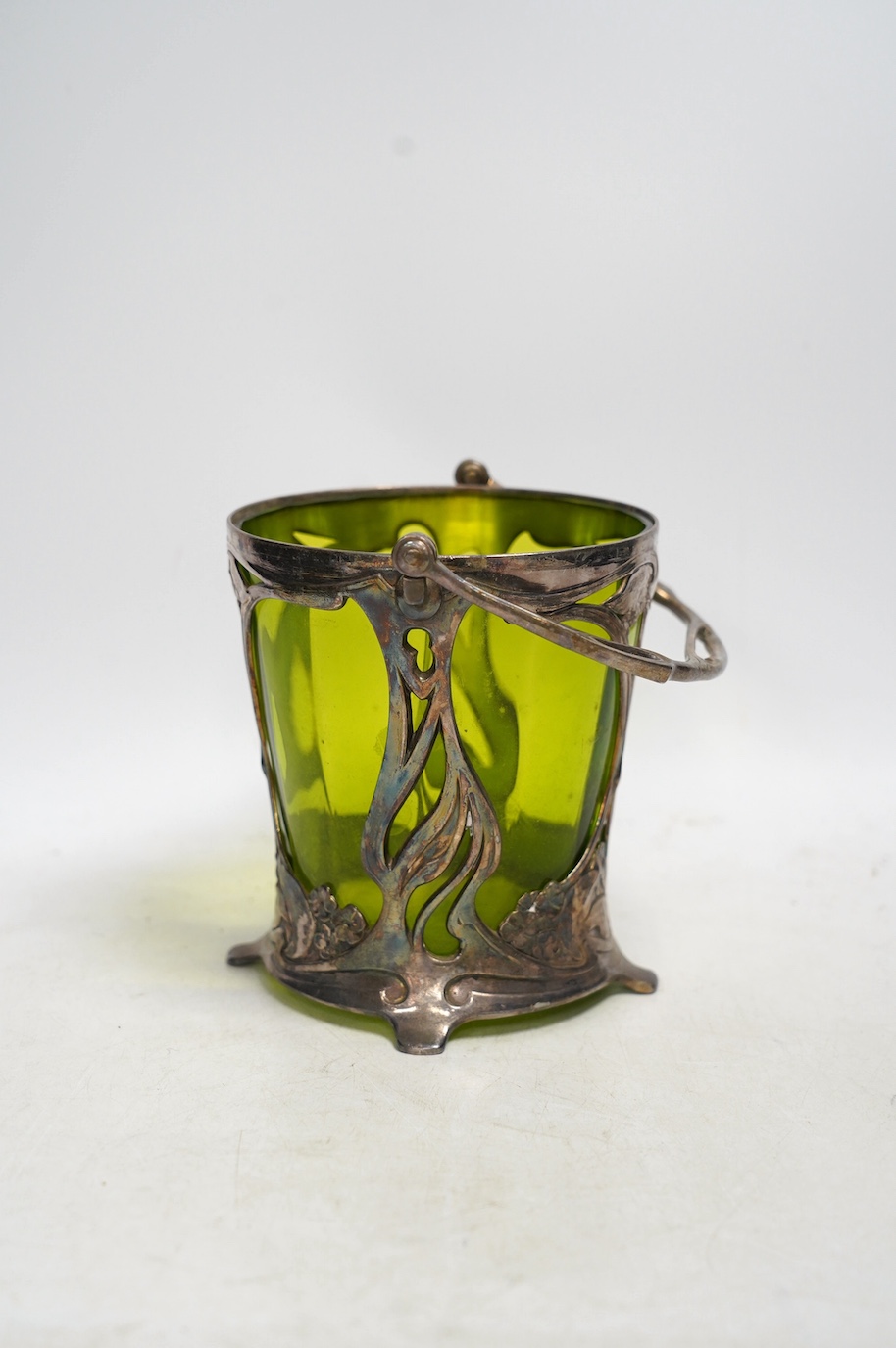 An Art Nouveau WMF pewter mounted biscuit jar with glass liner, lacking cover, stamped to the base, 23cm high including handle. Condition - fair